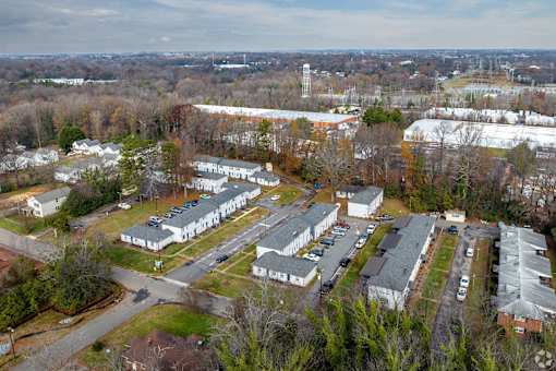 An aerial view of a residential area with houses and apartment buildings.