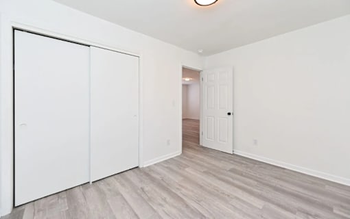A room with a white door and a white wall.