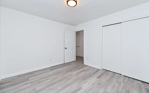 A room with a white door and a white wall.