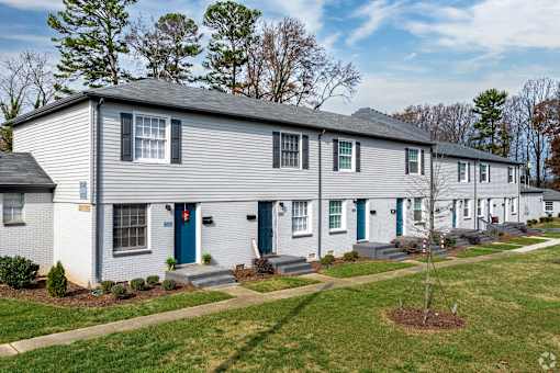 A row of houses with blue doors and windows.