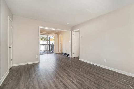 A room with wooden floors and white walls.