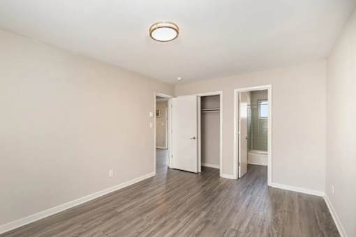 A room with a white door and a window.