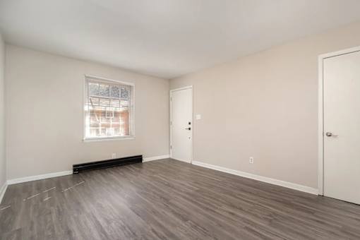 A room with a window and a door.