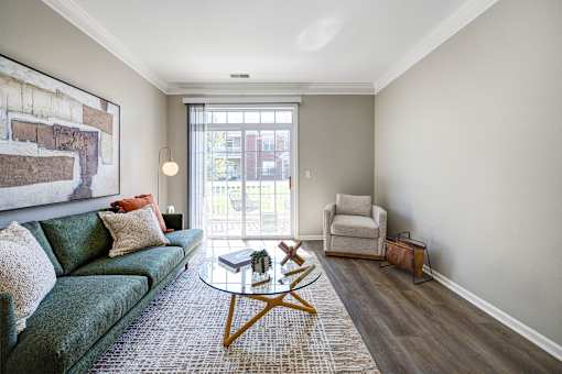A living room with a green couch and a coffee table.