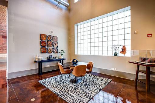 dining table on a rug in front of a large window