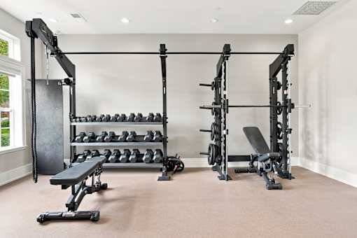 A well-equipped home gym with a variety of weightlifting equipment.