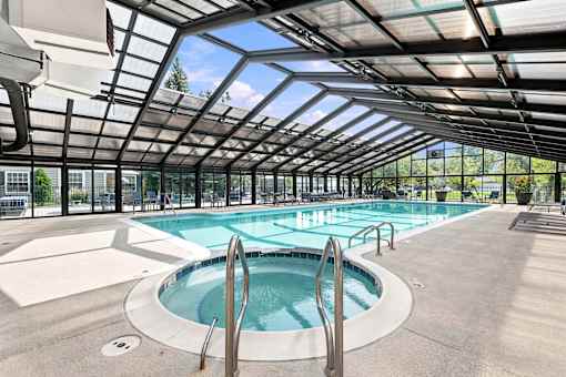 A large indoor pool with a glass ceiling.