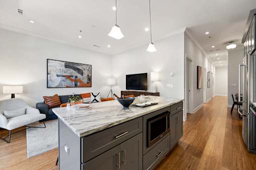 A modern kitchen with a marble countertop and a large island.