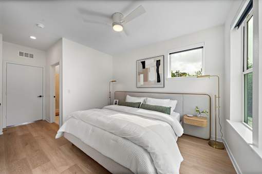 A bedroom with a large bed and a window.