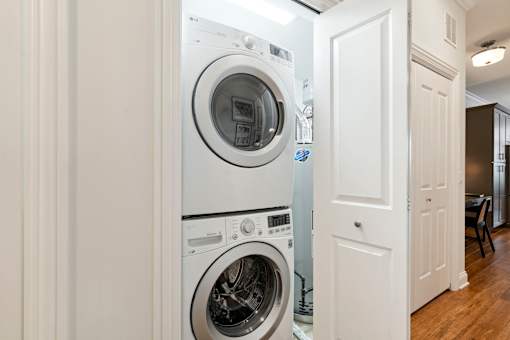A white washing machine and dryer in a small laundry room.