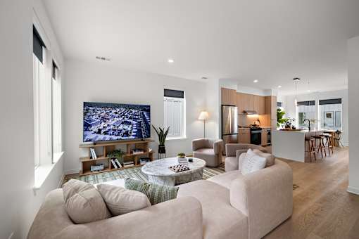 A modern living room with a large couch and a television.
