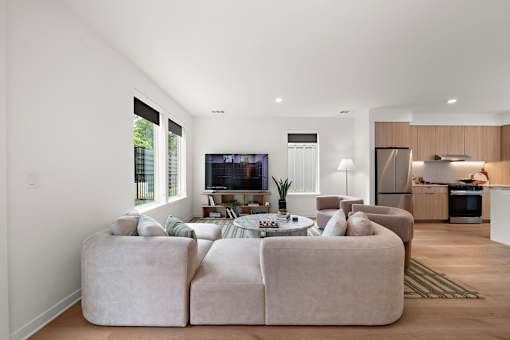 A modern living room with a large sectional sofa and a television.
