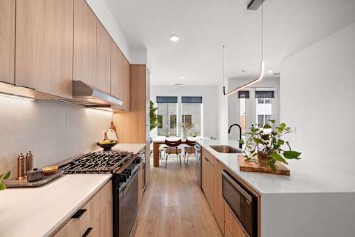 A modern kitchen with wooden cabinets and a white countertop.