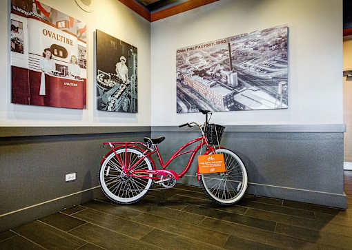 red bike in front of a wall
