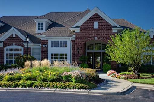 a large house with a driveway and landscaping in front of it