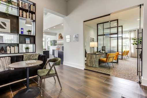 a living room and dining room with a table and chairs
