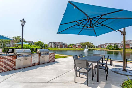 our patio with a table and chairs and an umbrella