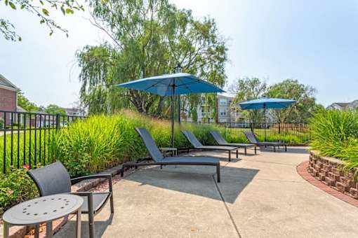 our patio has umbrellas and chairs and tables