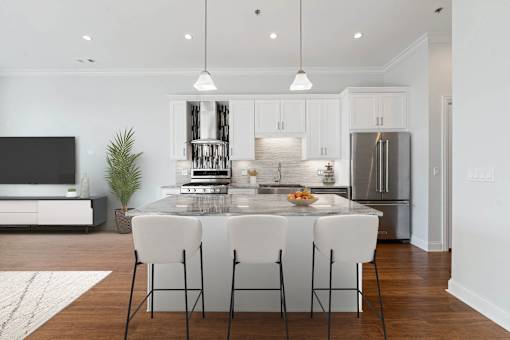 A modern kitchen with a dining table set for four.