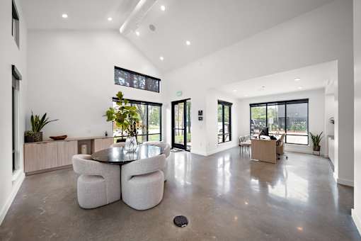 A modern living room with a glass door leading to a balcony.