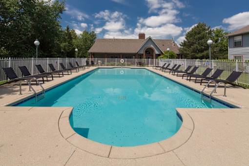 A large outdoor swimming pool surrounded by lounge chairs.
