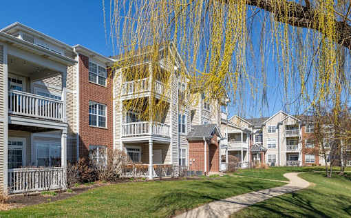 a row of apartments with balconies and a sidewalk