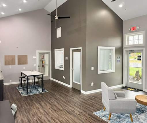 a living room with gray walls and a table and chairs