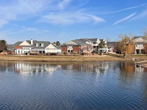 a body of water with houses in the background