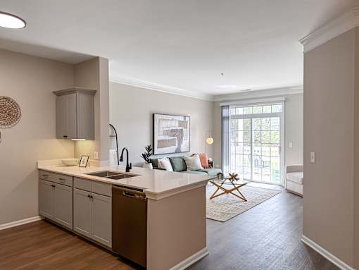 A kitchen with a sink and a fridge.