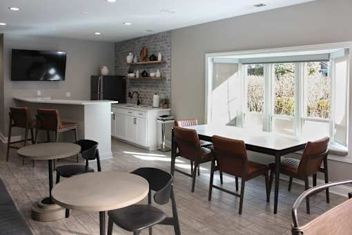 A modern kitchen with a dining table and chairs.