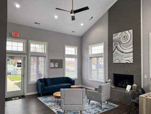 a living room with couches and chairs and a fireplace