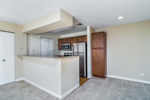 A kitchen with white cabinets and a white island.