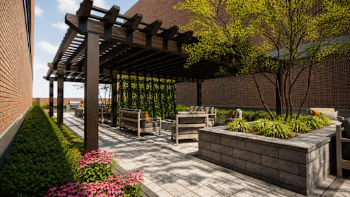A wooden pergola over a patio with a bench and a planter.