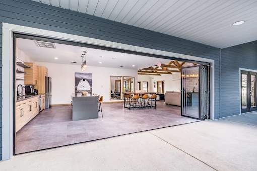 A modern house interior with a kitchen, dining area, and living room.