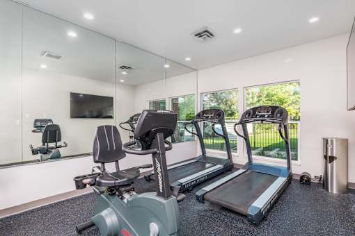 A gym with treadmills and exercise bikes.