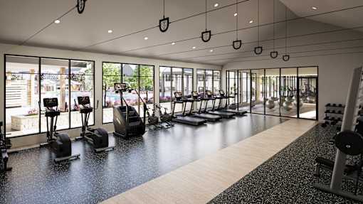 A gym with a variety of equipment including treadmills, weights, and exercise bikes.