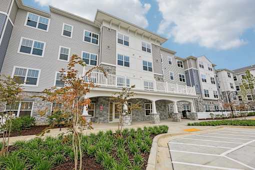 Willow Manor at Cabin Branch – Senior 62+ apartment community exterior in Clarksburg, MD with landscaped grounds and modern architecture