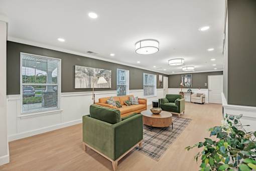 A living room with a green couch and a wooden coffee table.