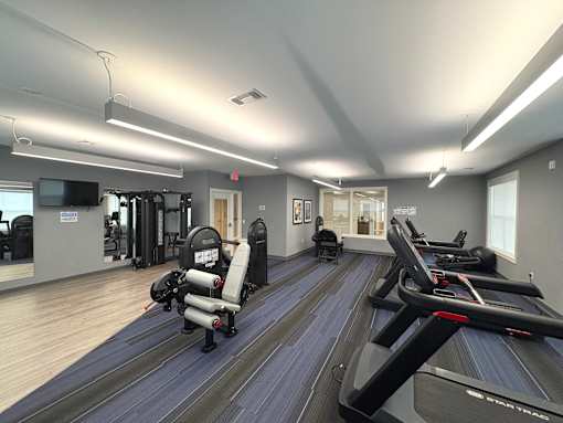 A gym with treadmills and exercise equipment.