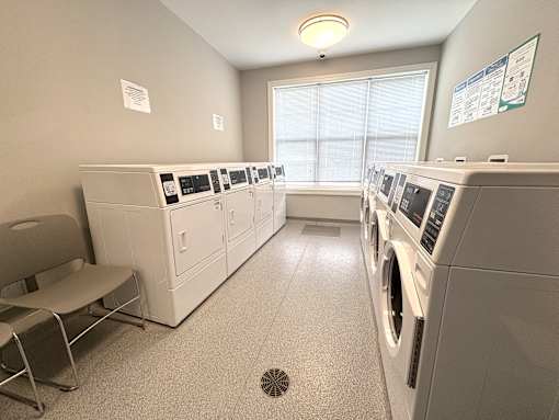 A laundry room with washers and dryers.