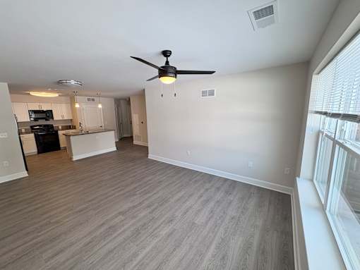 A room with a ceiling fan and light fixture.