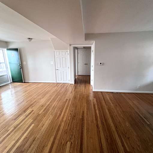A room with wooden floors and white walls.