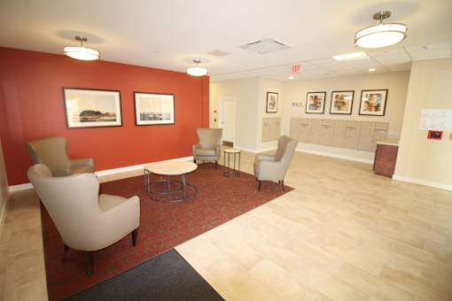 A waiting room with chairs and pictures on the wall.