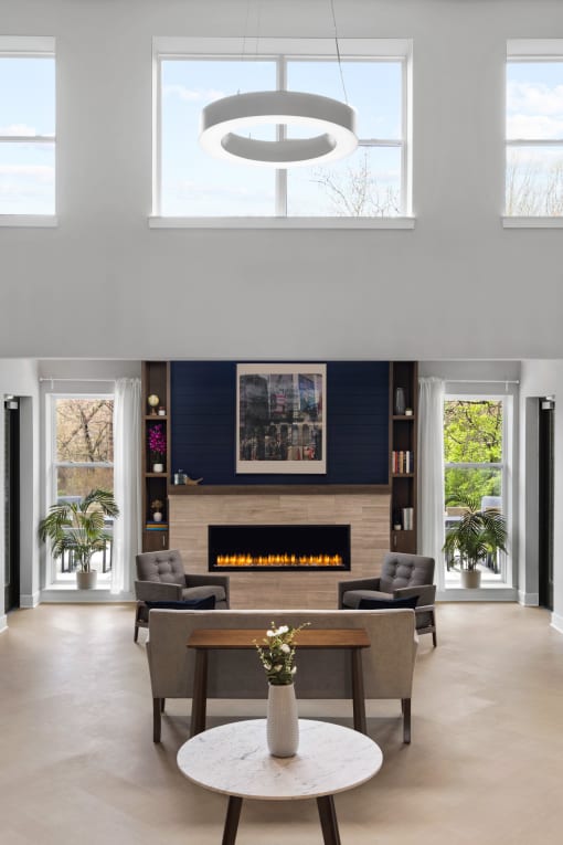 a living room with a fireplace and a table and chairs