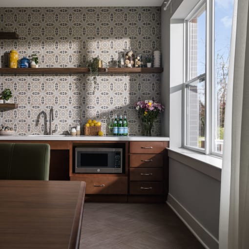 a small kitchen with a microwave and a table