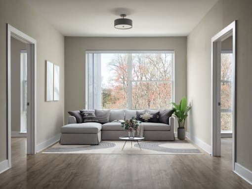 a living room with a couch in front of a window