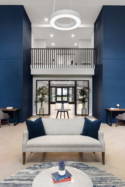 a living room with blue walls and a white couch