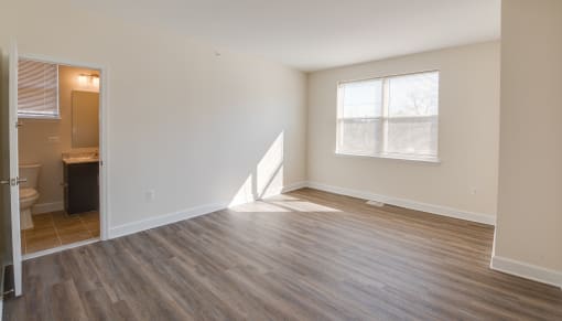 a bedroom with hardwood flooring