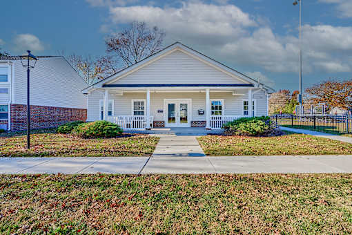 a white house with a sidewalk in front of it