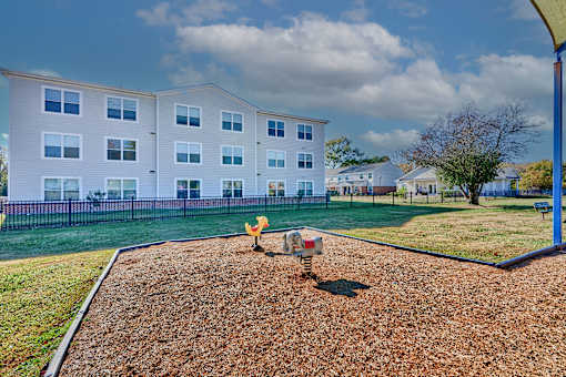 a playground with a fire hydrant in front of a building